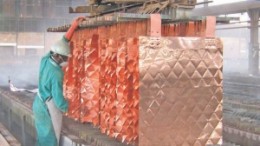 A worker inspects copper sheets at Katanga Mining's Luilu metallurgical plant in the Democratic Republic of the Congo.