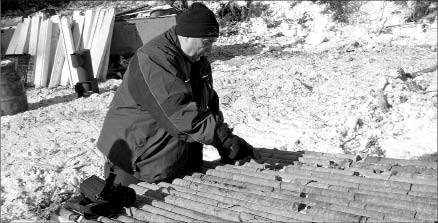 Pacific North West Capital director John Londry looks at core at the River Valley PGM project in northern Ontario. Photo by Pacific North West Capital