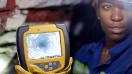 A worker displays a drill-hole-camera image at Great Basin Gold's new Burnstone gold mine in South Africa. Photo by Ian Bickis.