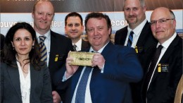 Osisko Mining president CEO Sean Roosen (centre) hoists the company's first gold bar, with members of the executive team at the company's general meeting in May. Photo by Osisko Mining