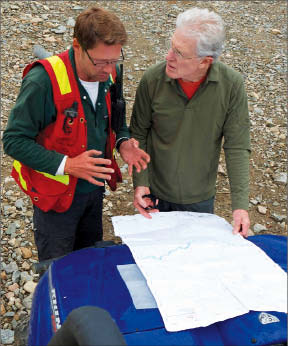 Rio Minerals' Andrew Molnar and Smash Minerals CEO Adrian Fleming study a map at Smash's Whiskey gold project in the Yukon's White Gold district. Photo by Smash Minerals