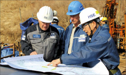 Studying a map at Woulfe Mining's Sangdong tungsten-molybdenum project in South Korea, from left: Bill Kable, vice-president technical; Arne Rahnel, manager of projects; and Wang In Jeon, safety manager. Photo by Woulfe Mining