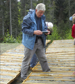 First Point Minerals president Peter Bradshaw looks at awaruite core at the Decar project in central British Columbia. Photo by Matthew Allan