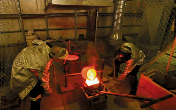 Workers pour gold at Bralorne Gold Mines' Bralorne mine near Gold Bridge, British Columbia. Photo by Bralorne Gold Mines