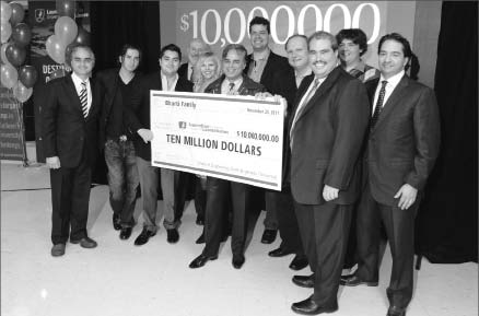 The Bharti family and colleagues present a $10-million cheque to Dominic Giroux, president and vice-chancellor of Laurentian University. Pictured, front row, from left: Tito Bharti (brother); Andr Bharti (son); Julian Bharti (son); Hannele Bharti (wife); Stan Bharti; Dominic Giroux; and Perry Dellelce. Photo by Laurentian University