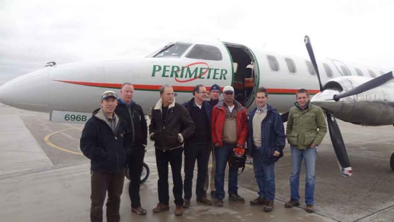 Foran Mining CEO Patrick Soares (third from right) with colleagues including Pierre Lassonde (third from left) and David Harquail (fourth from left) at the airport in Winnipeg, Manitoba. Photo by Foran Mining