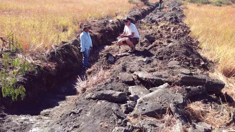 Energizer Resources senior vice-president of operations Craig Scherba (right) and a local worker examine a trench at the Green Giant graphite project in Madagascar. Photo by Matthew Keevil