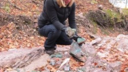 Superior's CEO and president, Judy Baker, examines the high-grade copper minerals on the Batchawana property.