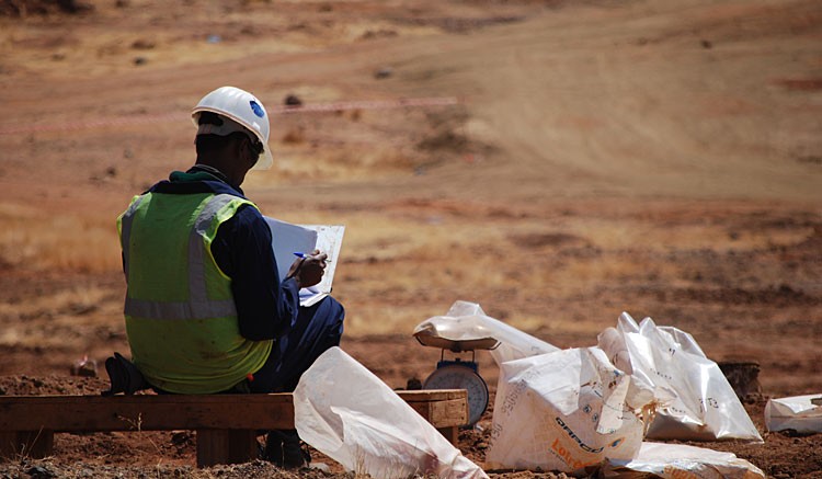 An Eritrean worker labels bags of reverse circulation drill chips at Nevsun's  Bisha mine. Photo by Gwen Preston
