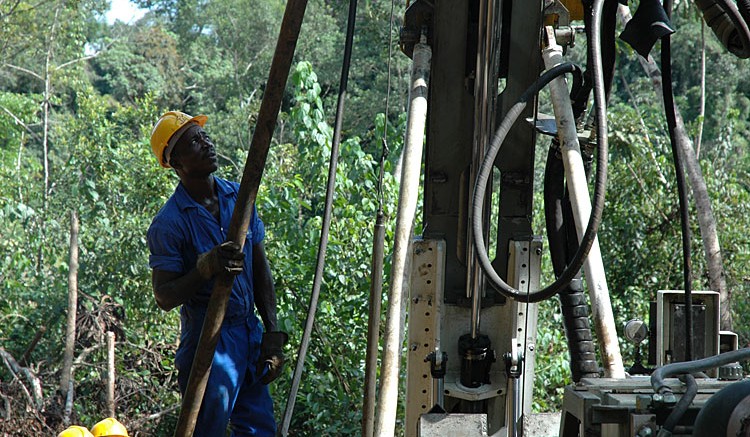 Workers attend to a drill rig at Aureus' New Liberty project in Liberia. Source: Aureus Mining