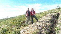 Project geologist Joe Currie and Kaminak Gold president and CEO Eira Thomas stand beside a Supremo zone trench at the Coffee gold project in western Yukon, 130 km south of Dawson City. Photo by Gwen Preston.