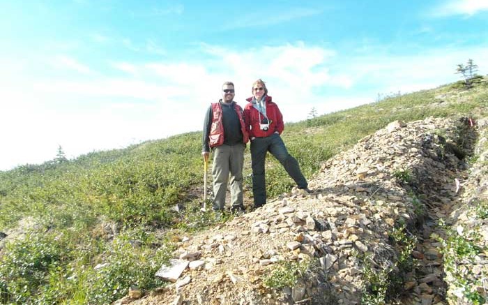 Project geologist Joe Currie and Kaminak Gold president and CEO Eira Thomas stand beside a Supremo zone trench at the Coffee gold project in western Yukon, 130 km south of Dawson City. Photo by Gwen Preston.