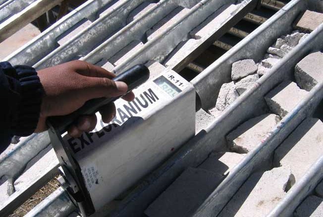 A worker takes measurements of rock samples. Credit: Macusani Yellowcake