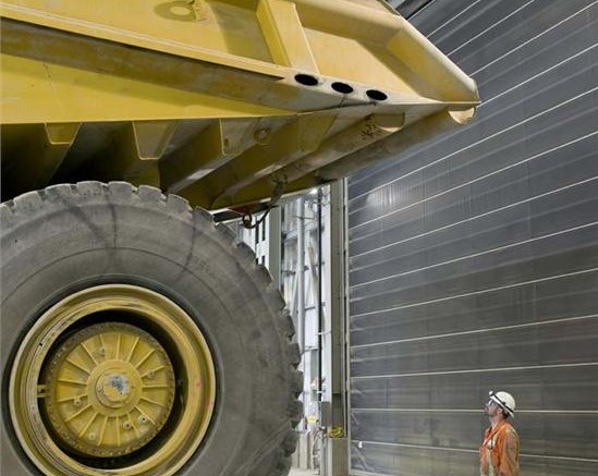 A dump truck dwarfs a worker at Detour Gold's Detour Lake gold mine in northeast Ontario.  Credit: Detour Gold