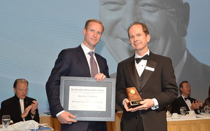 Doug Donnelly (right), Canadian Mining Hall of Fame director and publisher of The Northern Miner, presenting to Gavin McOuat, son of inductee Jack McOuat. Credit:  Canadian Mining Hall of Fame