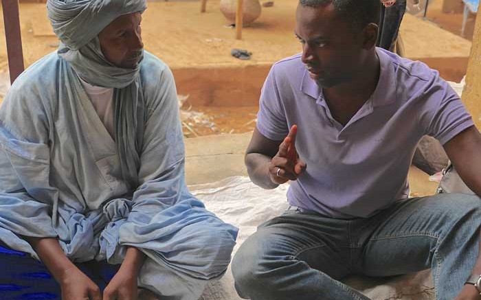 Great Quest Metals CEO Jed Richardson (right) speaks with a merchant in Gao, Mali. Credit: Great Quest Metals