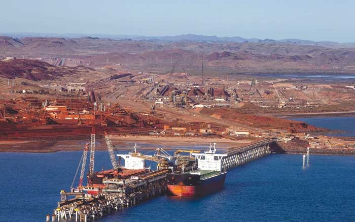 A ship receives a load at Rio Tinto's Pilbara iron-ore mining complex in Australia. Credit:  Rio Tinto