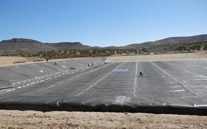 Workers lining a pond that will hold pregnant solution at Midway Gold's Pan gold project, 35 km southeast of Eureka, Nevada.  Credit: Midway Gold