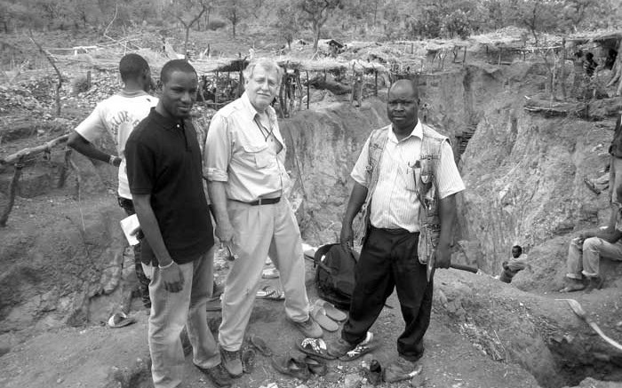 Surrounded by artisanal workings at the Diakha discovery zone at Merrex Gold and Iamgold's Siribaya gold project in Mali, from left (facing the camera): Aboubacar (Eby) Sylla, owner of Touba Mining, a strategic project partner; Greg Isenor, president of Merrex Gold; and Mamadou Diallo, Touba Mining geologist. Credit: Merrex Gold