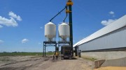 A truck underneath a frac sand silo beside a storage house at Victory Silica's Seven Persons frac sand plant. Photo by Matthew Keevil.