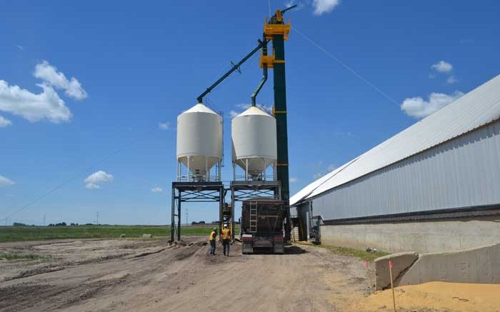 A truck underneath a frac sand silo beside a storage house at Victory Silica's Seven Persons frac sand plant. Photo by Matthew Keevil.