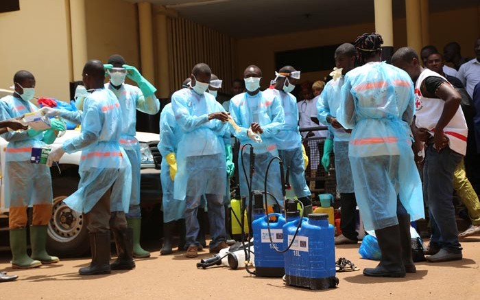 Volunteers with the Red Cross Society of Guinea prepare to disinfect a hospital in Conakry, Guinea, following the Ebola outbreak in April. Credit: European Commission DG Echo