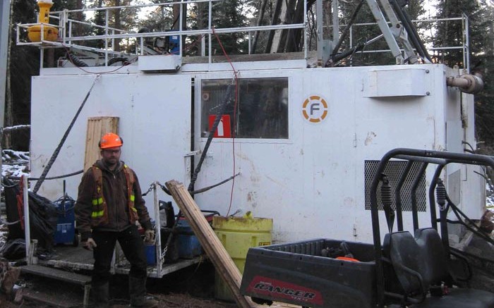 Transition Metals geologist Steve Flank standing in front of the discovery hole at the Sunday Lake PGM project, 25 km north of Thunder Bay, Ontario, in November 2013. Credit: Transition Metals