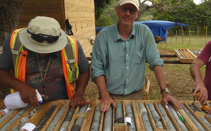 Precipitate Gold vice-president of exploration Michael Moore (facing camera) analyzes core from discovery hole 5 at the Ginger Ridge zone, part of the Juan de Herrera gold project in the Dominican Republic. Credit: Precipitate Gold