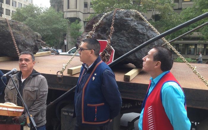 Returning iron-ore boulders to Iron Ore Co. of Canada's head office in October, from left: Florent Vollant, songwriter and composer; Mike McKenzie, chief of Uashat Mak Mani-Utenam Innu; and Ral McKenzie, chief of the Matimekush-Lac John Innu. Credit: Innu Takuaikan Uashat Mak Mani-Utenam