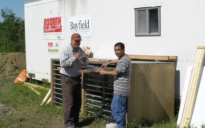 Bayfield Ventures' vice-president of exploration Bob Marvin (left) and project geologist Shane Hu examine core at the Burns Block gold project in Ontario.   Credit: Bayfield Ventures