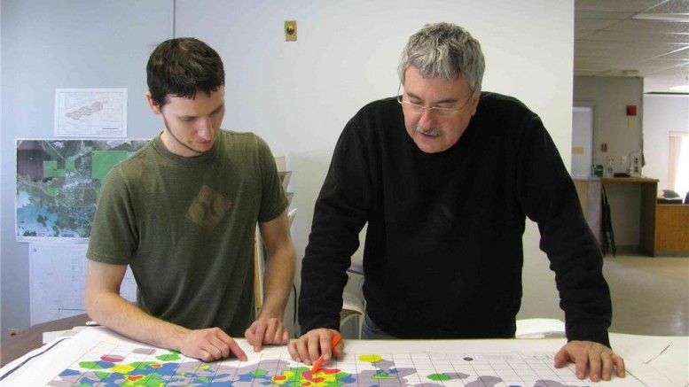 Project geologists Adam Larsen (left) and Paul Dunbar examine a map of Treasury Metals' Goliath gold project. Credit: Treasury Metals