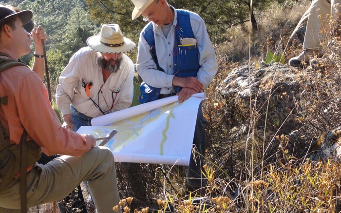 Geologists examine a map at Almaden Minerals' Ixtaca epithermal gold-silver deposit 95 km  north of Puebla City, Mexico. Credit: Almaden Minerals