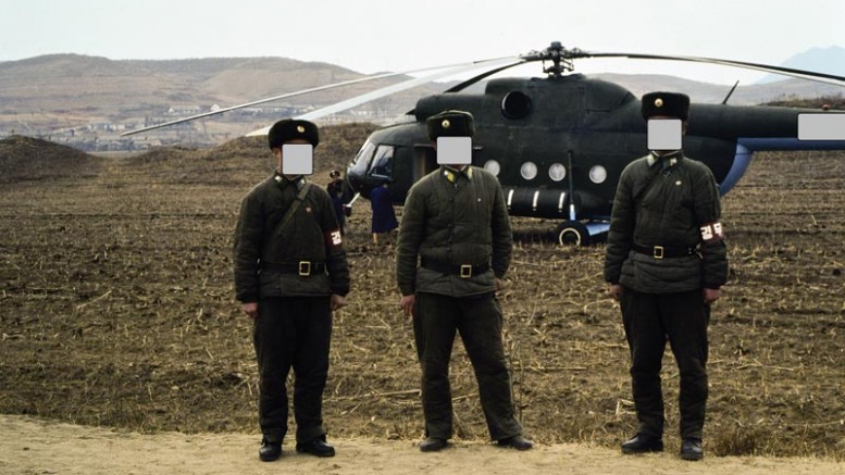 Soldiers guarding our Russian helicopter used to tour gold mines in North Korea in 1993. (Faces covered to hide their identities.)  Photo by David Tyrwhitt