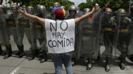 AFP photo of protester in Caracas, Venezuela, with sign reading "There is no food." Credit: AFP/file.