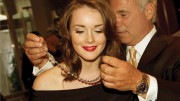 Birks' senior VP John Orrico helps actress Allie MacDonald with a 75-carat rough diamond necklace made with gems from De Beers' Victor mine, in Ontario. Credit: Birks & Mayors.