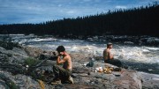 Angus Wilbur (left) and Vernon Smith have lunch near Iroquois chute on the Nottaway River in the Evans Lake area of northwestern Quebec in the summer of 1959. Photo by Harold Linder.