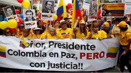 Protesters in Bogota, Colombia, march in April 2016 against the peace talks led by President Juan Manuel Santos. Credit: AP/Humanosphere.