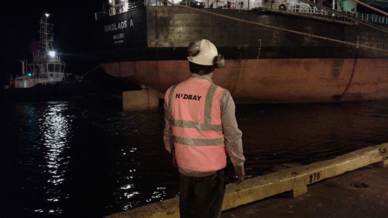 A worker watches the first load of concentrate from Hudbay Minerals' Constancia copper-moly-gold-silver mine leave for China from Peru. Credit: Hudbay Minerals.