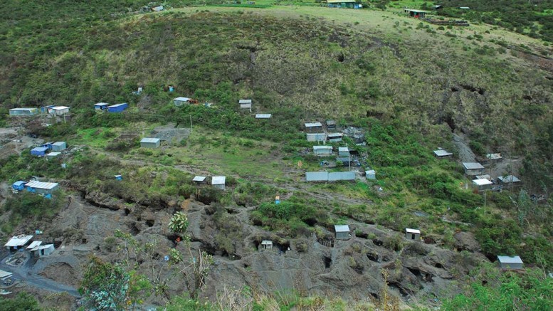 At Minera IRL’s Ollachea gold property in Peru, showing areas mined by local artisanal miners at the bottom. The house near the top with the blue drums is where a second mine portal will be and the flat area is where a tails paste plant will be located. Photo by Paul Harris.