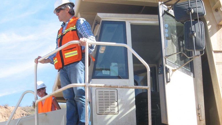 Rob McEwen perched on a large mining truck at McEwen Mining's El Gallo gold project in Mexico. Credit: McEwen Mining.