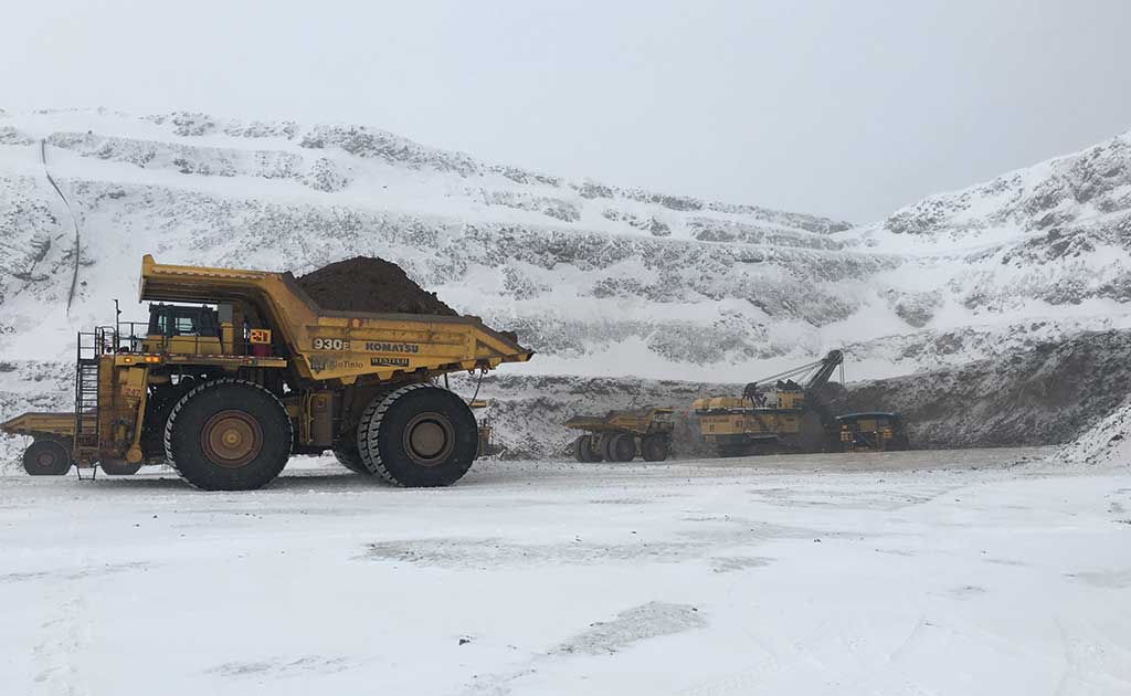 Haul trucks with a shovel in the background at Iron Ore Co. of Canada's Wabush 3 iron ore mine in Labrador. Credit: Rio Tinto.