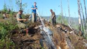 Washing down the discovery outcrop of the Goldstack zone at Goldstrike Resources' Plateau South property in the Yukon in 2013. Credit: Goldstrike Resources.