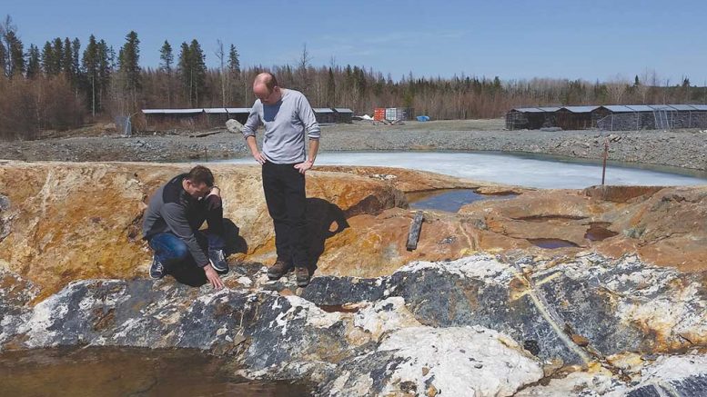 Probe Metals’ vice-president of corporate development Patrick Langlois (left) and chief operating officer Yves Dessureault examine outcrop at the Val-d’Or East gold property in Quebec. Credit: Probe Metals.