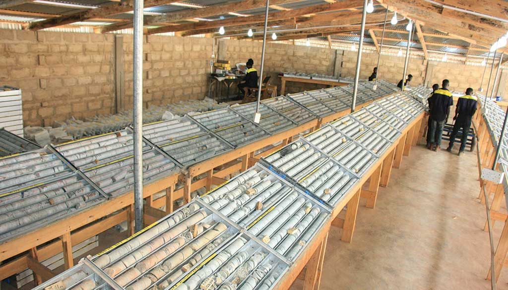 Workers in the core shack at the Namdini gold project. Credit: Cardinal Resources.