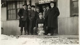 J.P. Bickell holding five gold bars while the McIntyre mine's directors look on. Credit: MacLachlan Family Collection.
