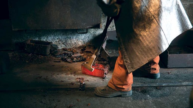 A worker handles a glowing-hot gold bar from Monarques Gold’s Beaufor gold mine, 20 km northeast of Val-d’Or, Quebec. Credit: Monarques Gold.