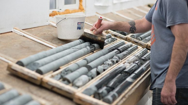 A worker wets drill core from the Colomac deposit at Nighthawk Gold’s Indin Lake gold project. Credit: Nighthawk Gold.