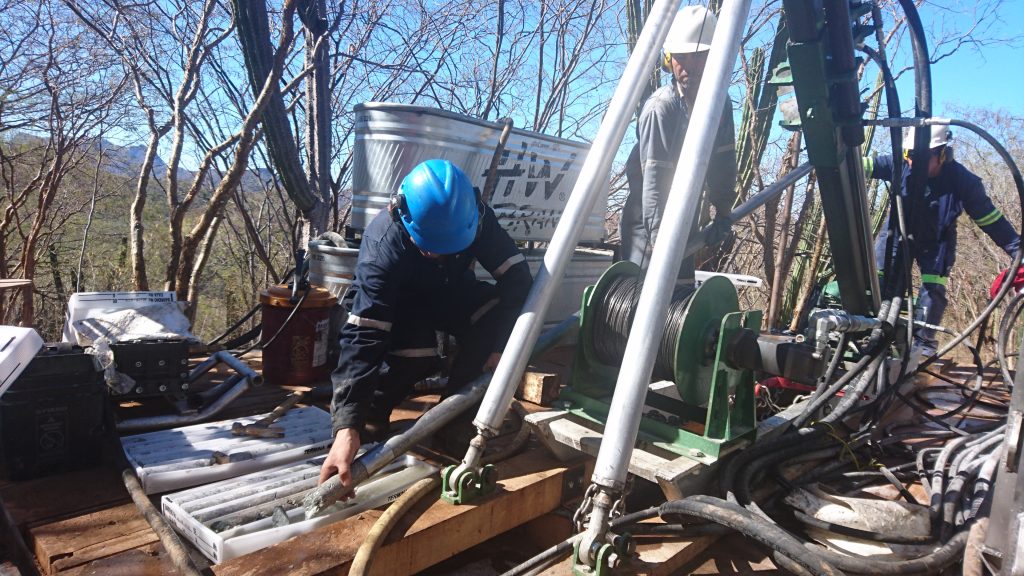 Minaurum workers remove core from a drill rig on the company's Alamos project. Photo by Richard Quarisa.