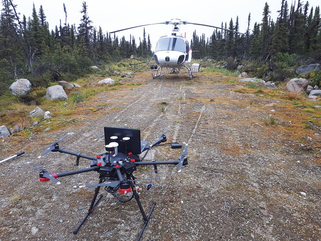 A surveying drone and a helicopter at a launch site on Bloom Lake East. Credit: Pioneer Aerial Surveys.