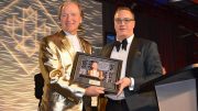 Northern Miner Group publisher Anthony Vaccaro (left) present Franco-Nevada chairman Pierre Lassonde with a memento to honour his serving as master of ceremonies at the Canadian Mining Hall of Fame’s induction ceremony for the past 18 years. Lassonde was inducted into the CMHF in 2013. Going forward, Vaccaro will take up the MCing duties at the annual CMHF induction ceremony. Photo Credit: Keith Houghton Photography.